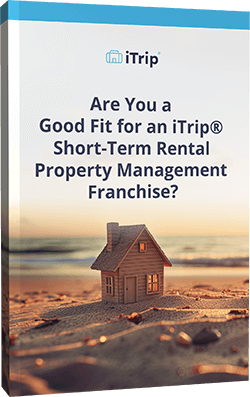 Cover of a guide featuring a miniature house on a beach with text reading, "Are You a Good Fit for an iTrip® Short-Term Rental Property Management Franchise?.